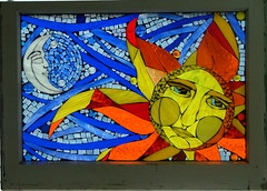 stained glass window of a sun and moon