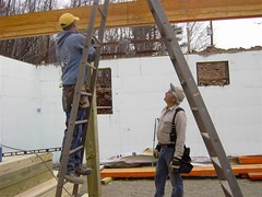 Installing one of the support posts under the beam
