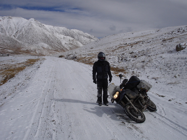 Tom takes a fall in the snow on the road just next to the Chinese/Pakistani border at the Kunjerab Pass on the Karakoram Highway