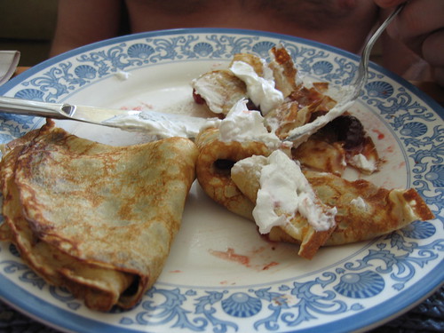 Devouring of crepes with a dollop of whipped topping