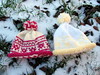 Two Fair Isle baby hats on a snowy day