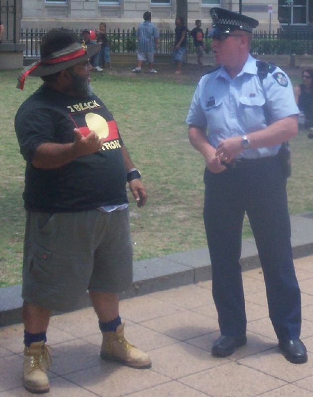 Sam Watson, rally organiser, discusses details with a police senior-sergeant - Justice for Mulrunji Rally at Queens Park and March through Brisbane City, Australia, November 18 2006