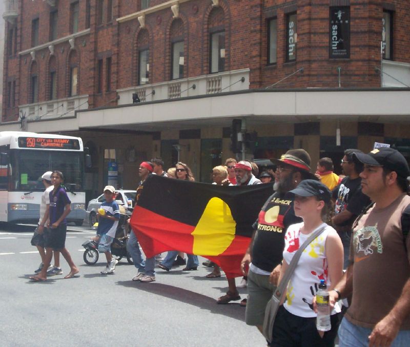Van of the march crosses Elizabeth St, heading towards the Botanic Gardens on Edward St - Justice for Mulrunji Rally at Queens Park and March through Brisbane City, Australia, November 18 2006