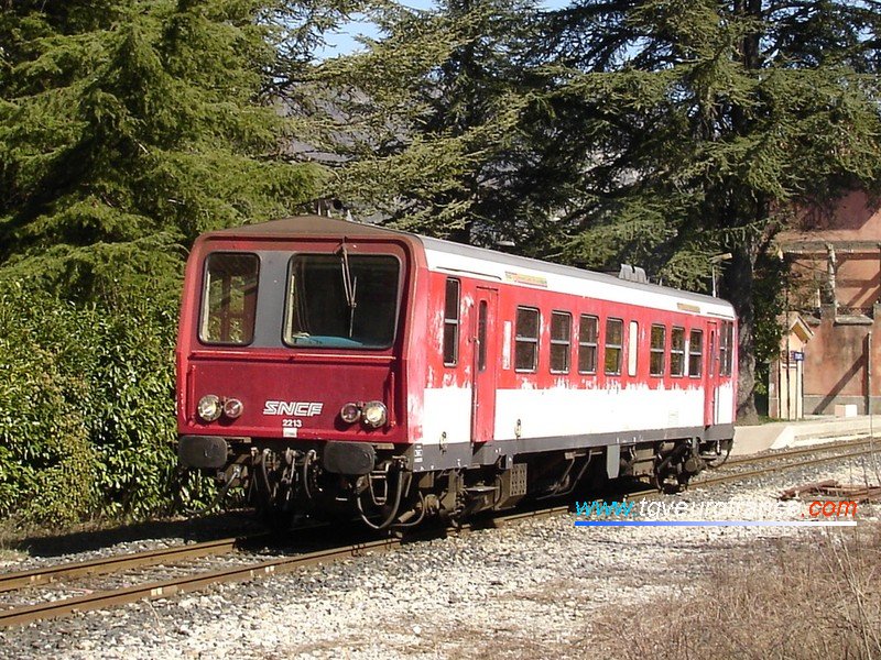 A detailed view of an X2200 railcar with its original red and white livery