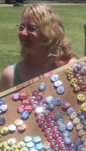 This badge seller appeared unready for criticism from an Aboriginal man - Justice for Mulrunji Rally at Queens Park and March through Brisbane City, Australia, November 18 2006