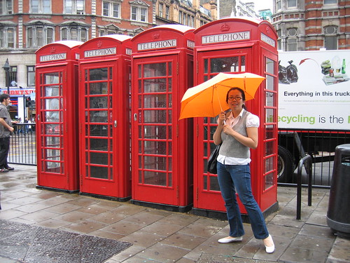 Singin' in the rain by London's trademark phone booths!