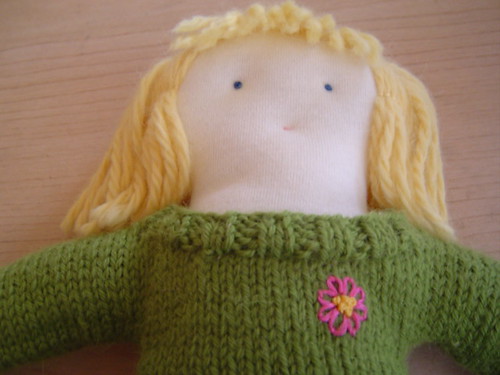 close up of embroidery on doll sweater