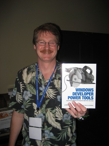 Jim Holmes holding his new book