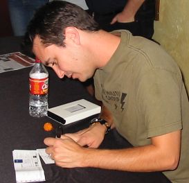 Wil Wheaton signing a card for the woman in front of me