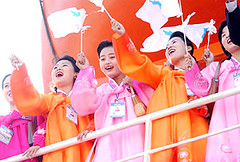 North Korean cheerleaders leave Busan Harbor about the Mangyeonbong-92 in 2002, to the cheers of hundreds of handpicked South Korean supporters