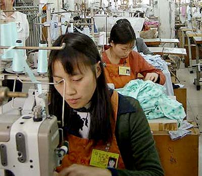 Two Chinese garment workers work on an order for Wal-Mart in Germany