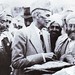 The Founder accepting a loaf of bread from tribesmen in Khyber Agency