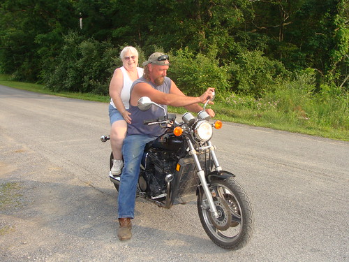 Margaret riding on a motorcycle in front of Sher's iwith daughter Sherri's brother-in-law Chris
