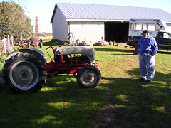 A farmer checking out grandpa's tractor