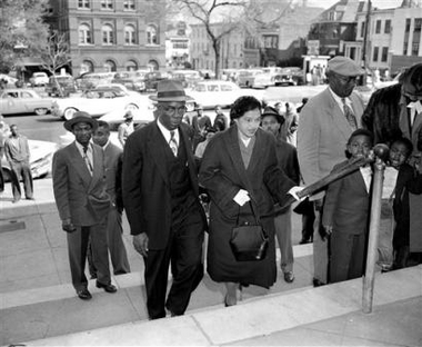 Rosa Parks is escorted by E.D. Nixon, former president of the Alabama NAACP, on arrival at the courthouse in Montgomery
