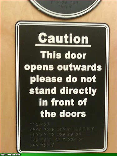 sign with Braille warning not to go near door