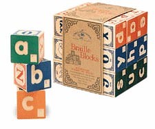 children's style colourful wooden blocks with the letters of the alphabet printed on them in Braille and Roman