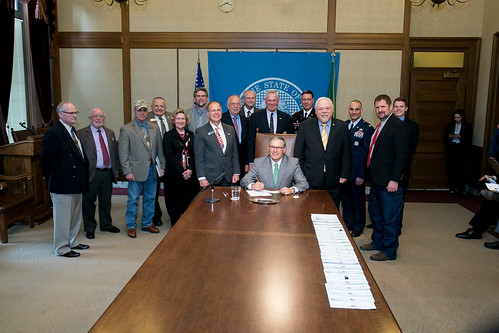 Gov. Jay Inslee signs Senate Bill No. 5775, April 2, 2014. Relating to allowing for a veteran designation on drivers' licenses and identicards.