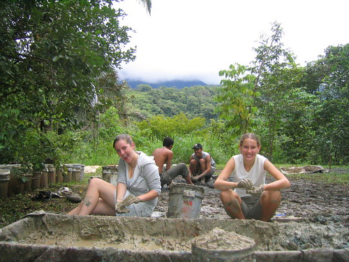 Clay sifting for Cob, Cob dancers in the background