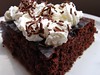 chocolate cake with whipped cream and chocolate sprinklers