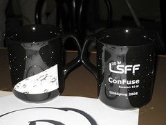 The front and back views of the LSFF mug: moon surface, and LSFF & ConFuse logos