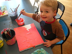 Finn painting pink at the art workshop