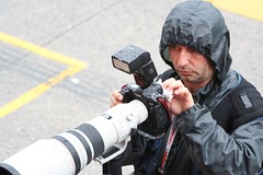 Working cameraman in heavy rain