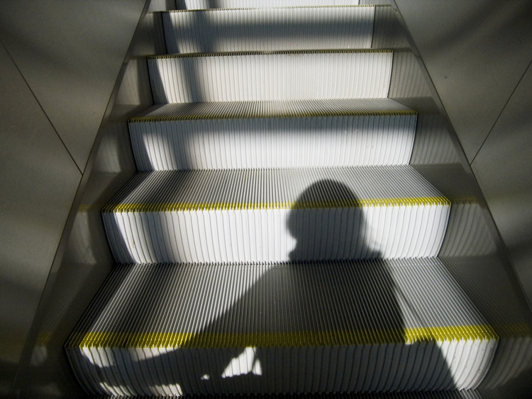 airport escalator with shadow