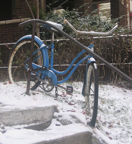 Bike chained to fence in snow