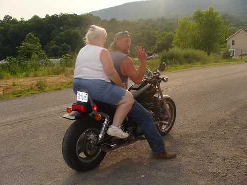 Margaret riding on a motorcycle in front of Sher's iwith daughter Sherri's brother-in-law Chris