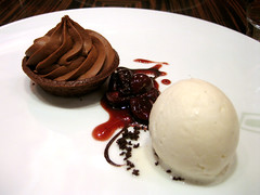 chocolate mousse tart thing with cherries and vanilla ice cream or something