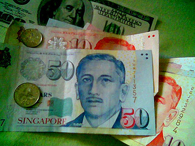 Money, money, and more money. A US dollar bill there and Singapore dollars here.