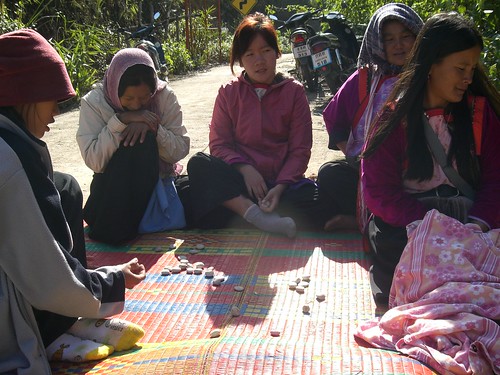 Women playing 'Jacks' with stones up in the Mountains