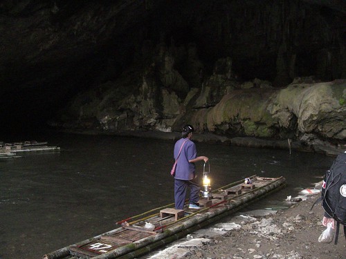 Our Guide and Bamboo Raft at the entrance to the Cave