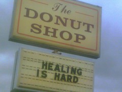 donut shop sign: 'healing is hard'