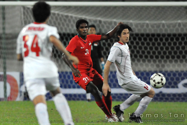  ... large singapore s hariss harun loses control of the ball to iran s