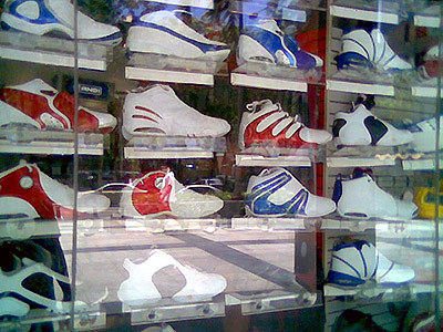 A window display of rubber shoes in one mall.
