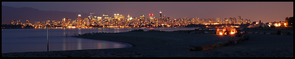 Vancouver skyline at night with beach fire
