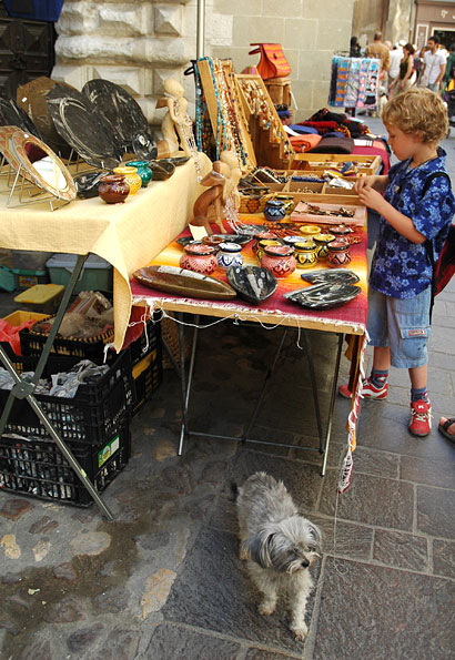 Craft stall with dog, Uzes, France, June 2006