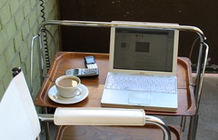 Laptop, phones and coffee on the balcony.
