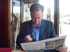 Doug Reads the Paper During Petit-Dejeuner