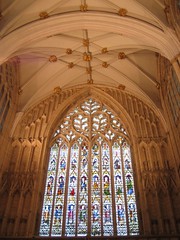 A stained glass and the ceiling in Minster