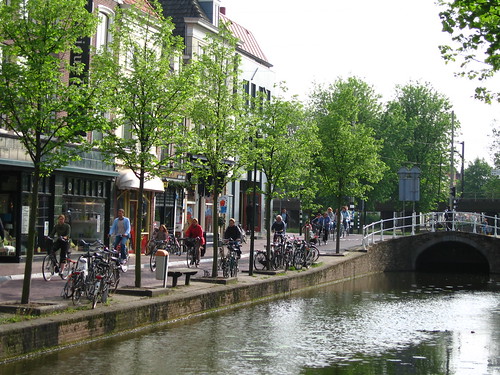 Cyclists along a canal in Delft