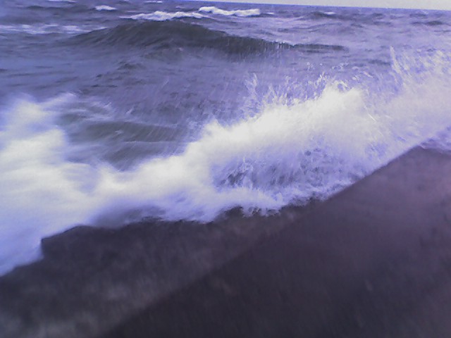 water coming over the edge of the grand haven pier - heavy seas 1
