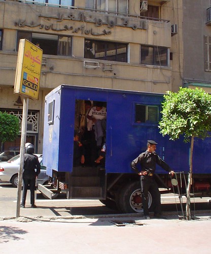 Uniformed police changing into plain cloth inside a state security armored car