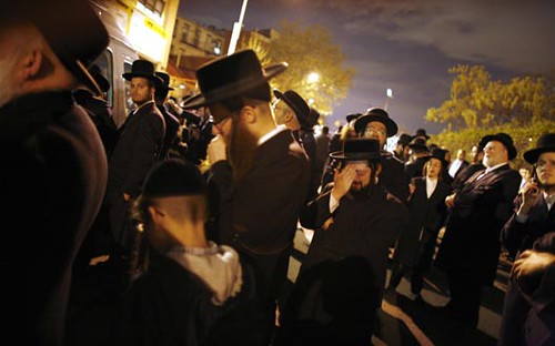 Mourners react during the funeral of Rabbi Moses Teitelbaum
