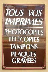 Sign on the wall outside a French print-products shop