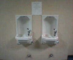 Sign says These faucets do not provide water. Nor do they drain well. Please do not empty cups here. Thank you.