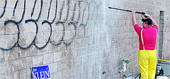 Cleaning offending graffiti from a supermarket in Throgs Neck, Bronx, NY