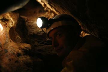 Hans Bluedorn crawling in tight passage in Mushroom Cave